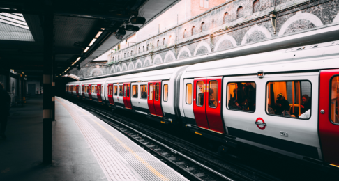 London underground train passing through an open-air station