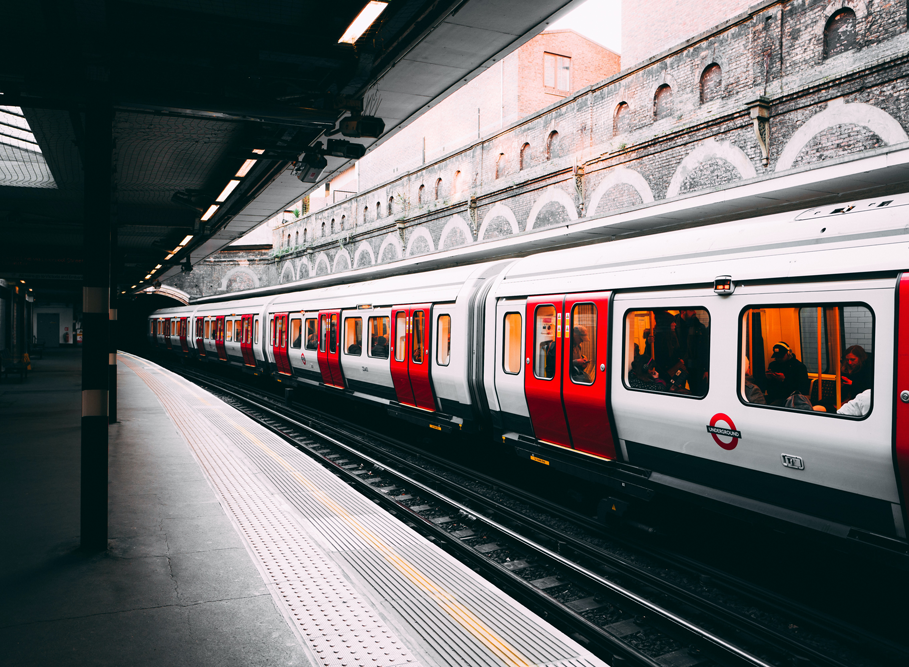 London underground train passing through an open-air station