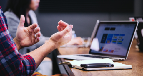 Man presenting to colleagues in a small meeting room