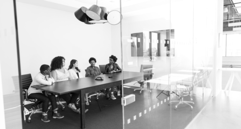 Business people in a boardroom behind a glass wall