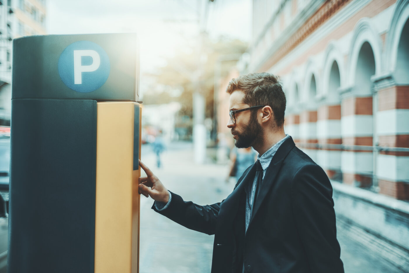 Man operates a parking ticketing machine