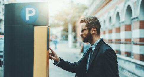 Man operates a parking ticketing machine