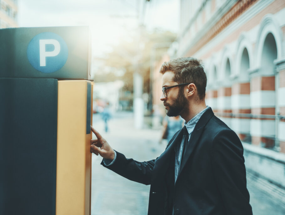 Man operates a parking ticketing machine