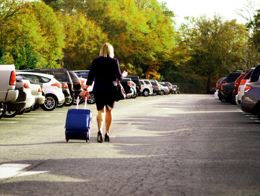 Businesswoman pulling suitcase.