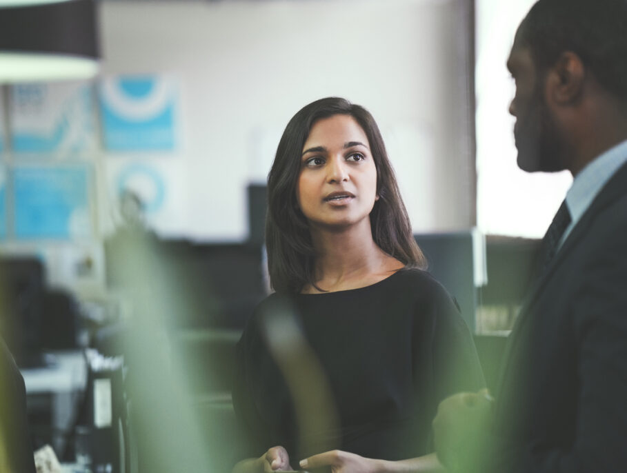 Businesspeople discussing items at work