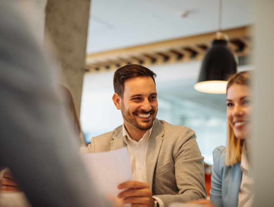 Man and woman laughing together in a meeting