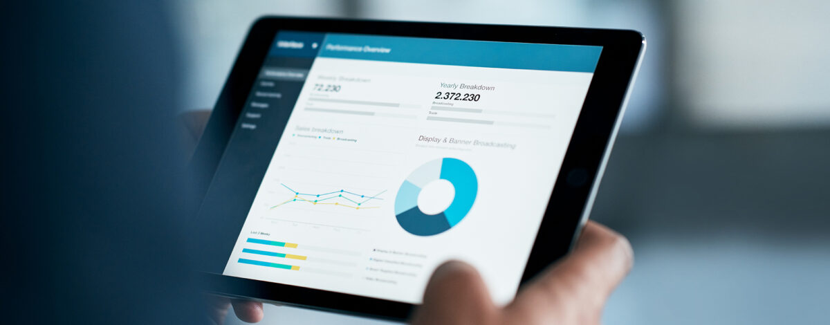 An iPad displaying a report of data and figures