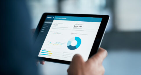 An iPad displaying a report of data and figures