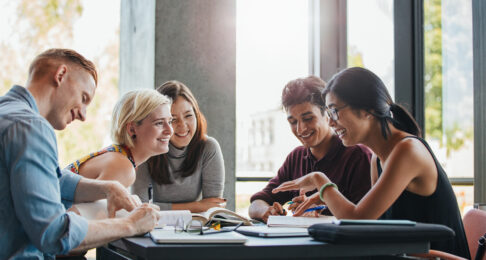 Group of people working together, laughing