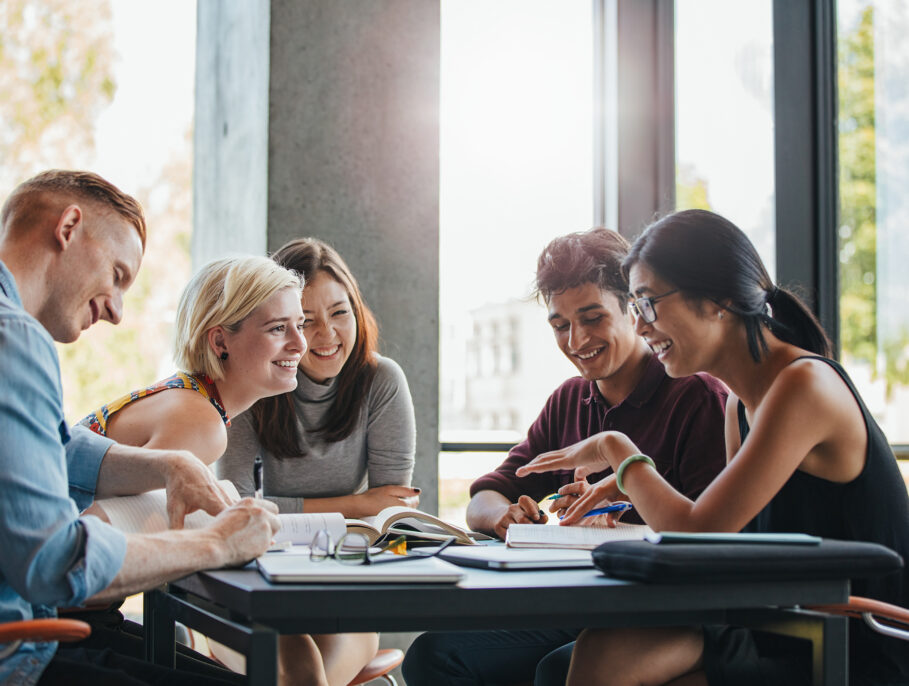 Group of people working together, laughing