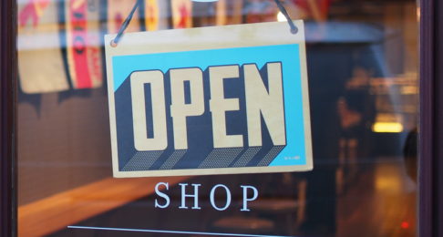 Shop open sign hung on a shop door