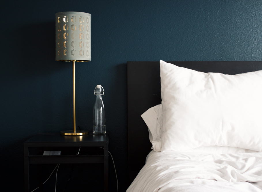 A hotel bedroom, with bedside table