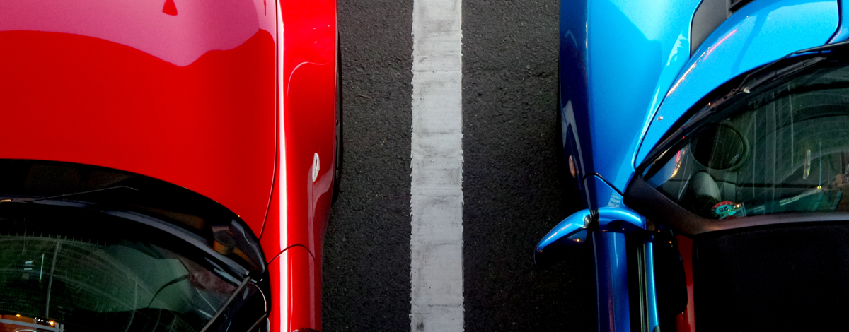 An aerial shot of two cars parked in their parking spaces