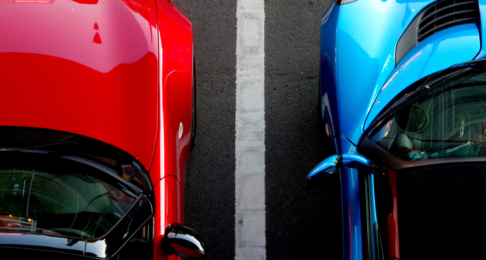 An aerial shot of two cars parked in their parking spaces