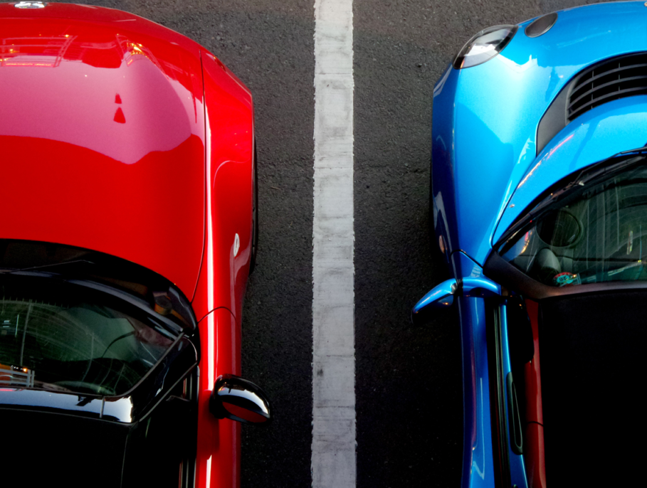 An aerial shot of two cars parked in their parking spaces