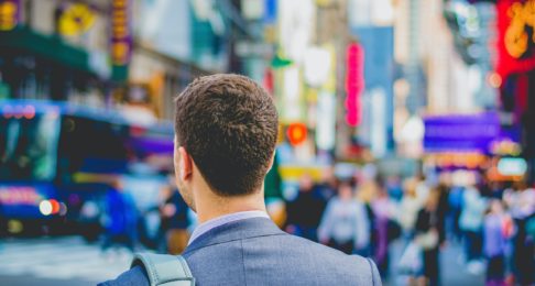 Office worker crossing the road in a busy city centre