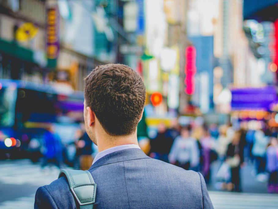 Office worker crossing the road in a busy city centre