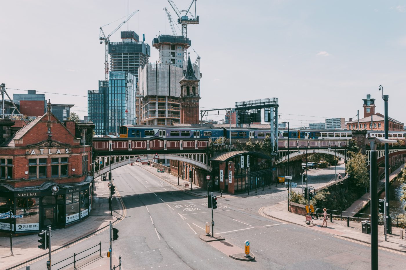 A quiet street in manchester overlooking the busy skyline