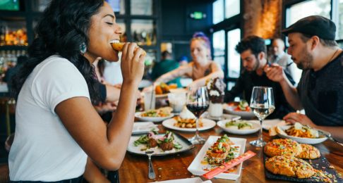 Woman tucking into food at a local restaurant