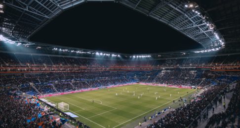 A lit up football stadium at night