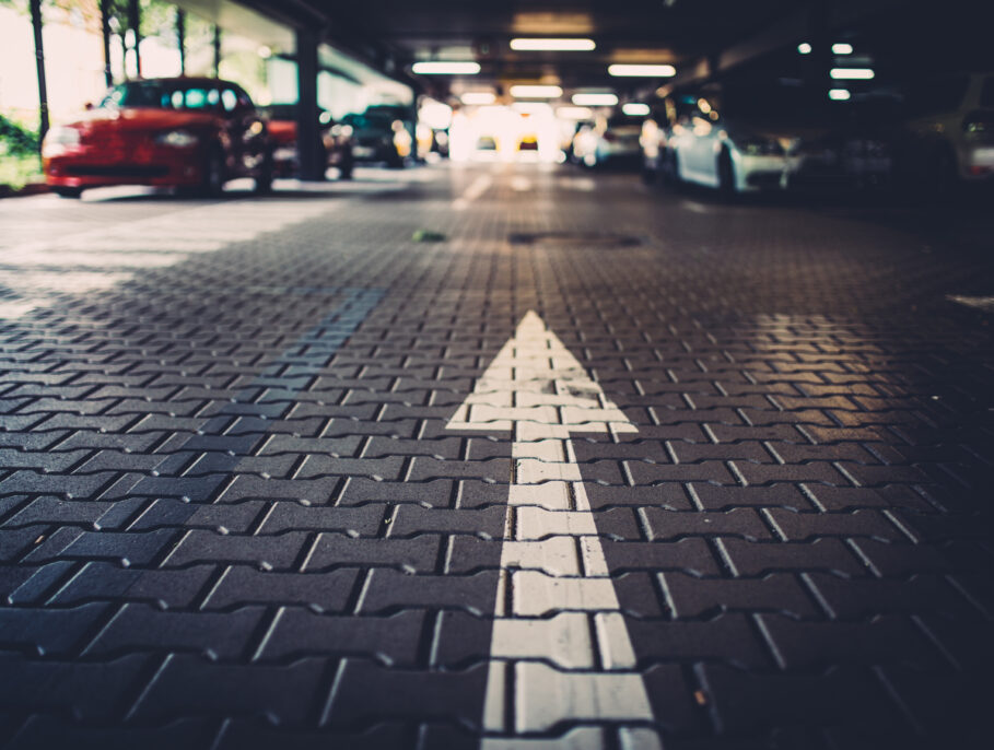 Arrow painted on the ground of a parking lot