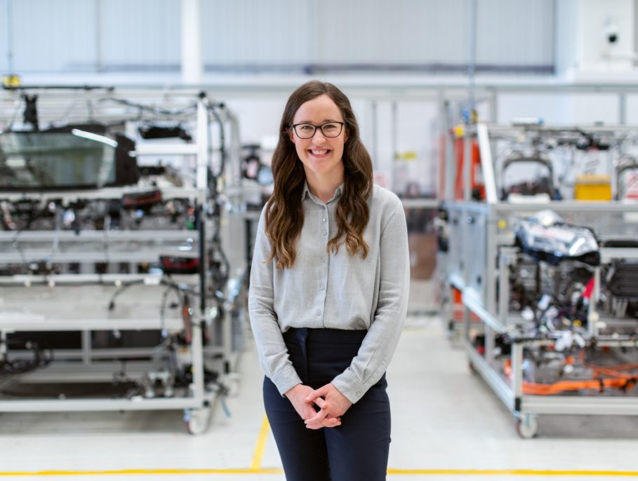 Engineer posing for a photo in a clean workshop
